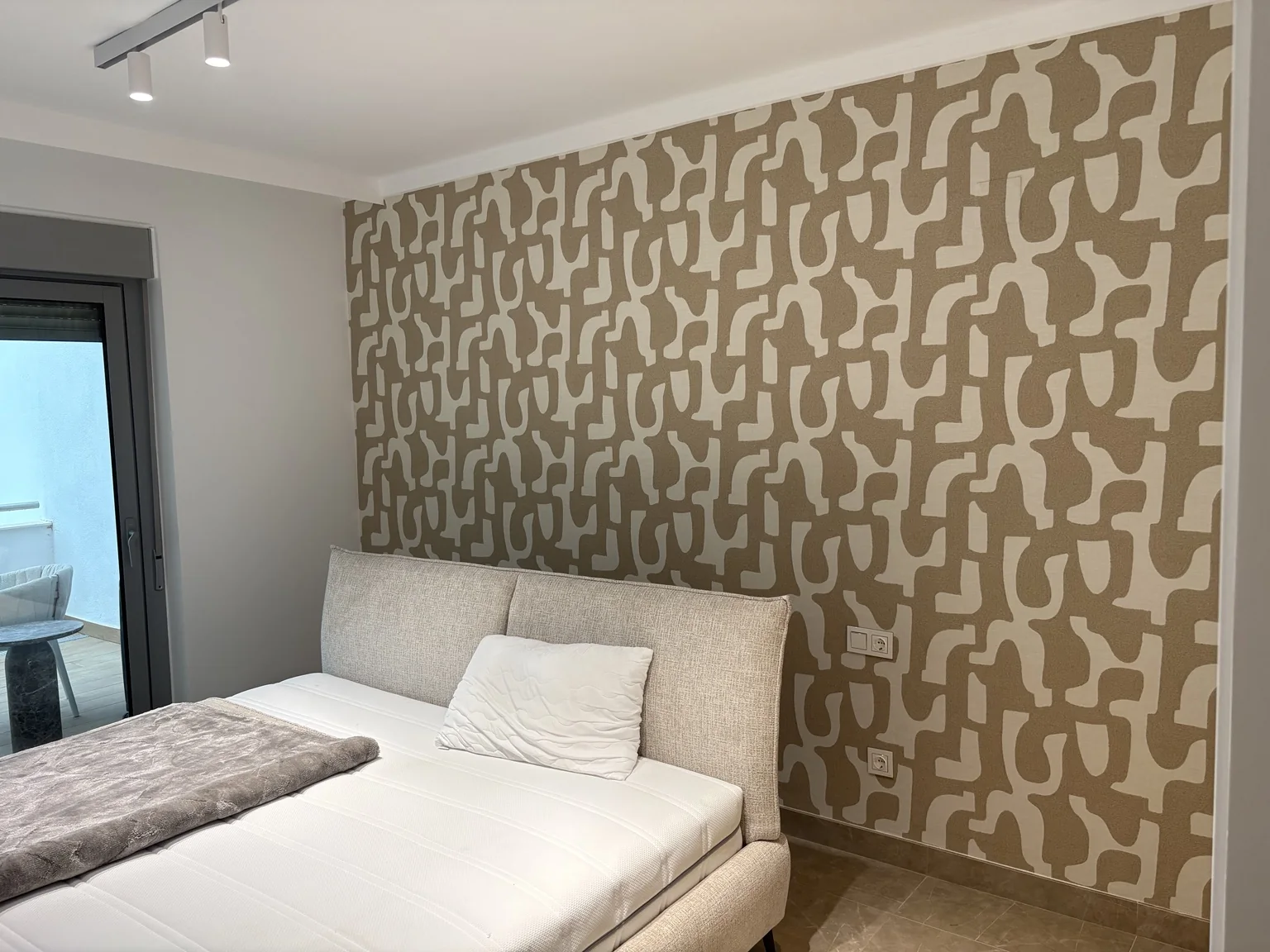 Geometric feature wallpaper installed in a bedroom
