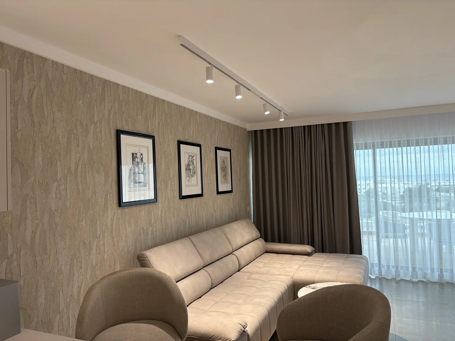 Textured neutral wallpaper installed in a living room